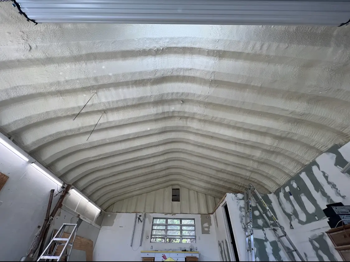 Spray polyurethane foam applied to the underside of a metal roof deck in Malone